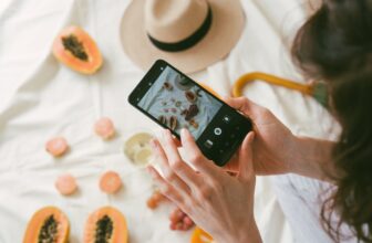 photo of person taking picture of fruits