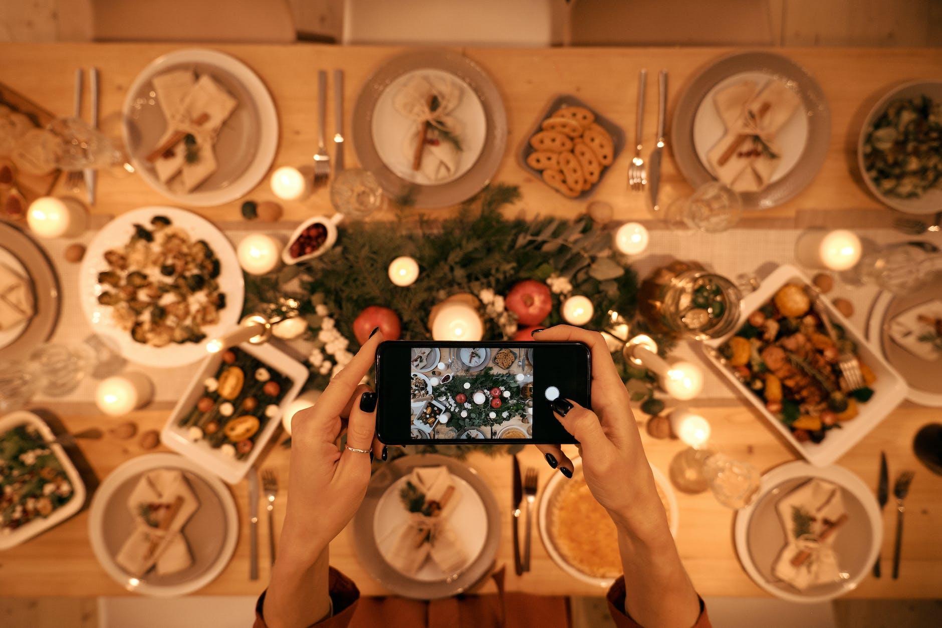 top view of a person taking picture of christmas dinner